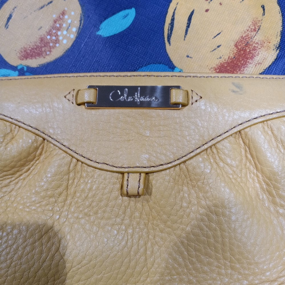Cole Haan gold leather wristlet